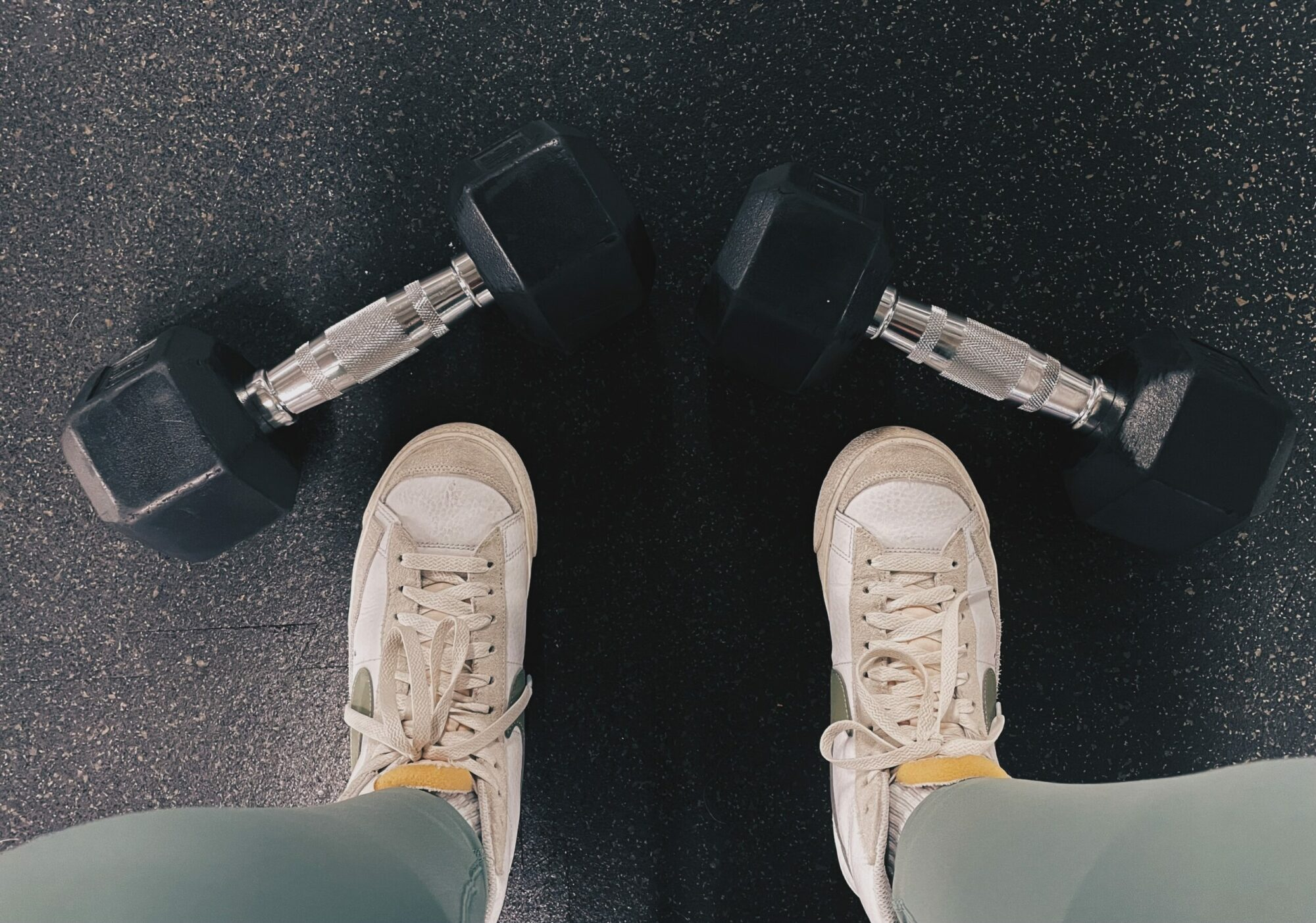 An image showing two feet with dumbbells next to them. The banner image of my peer's blog - Fueling Your Twenties: A Guide to Fitness and Nutrition.