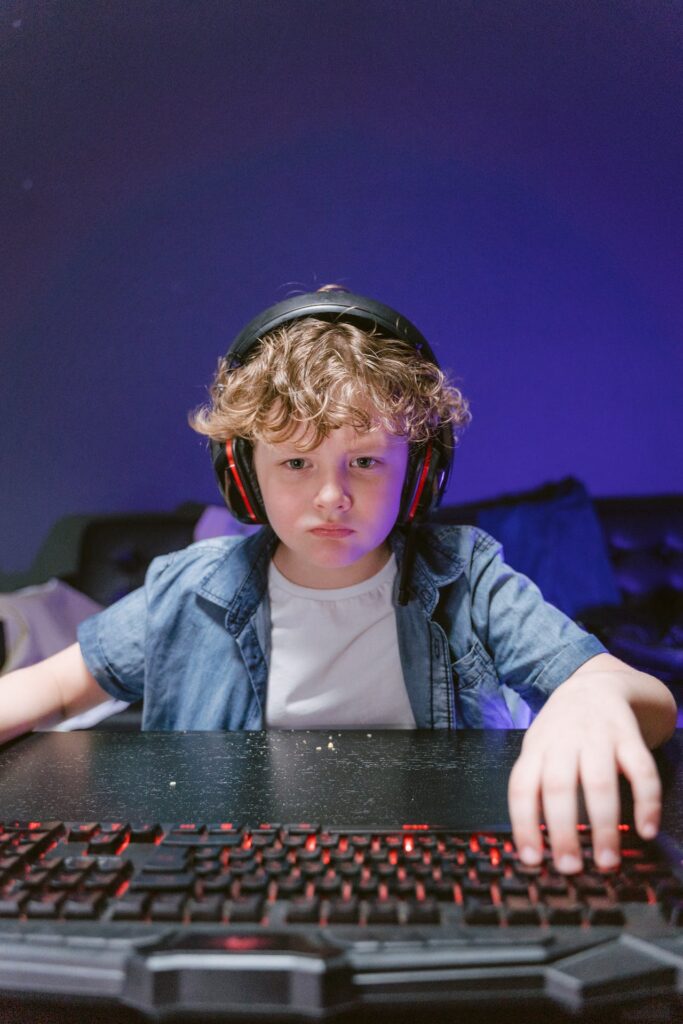 A young child playing on their PC